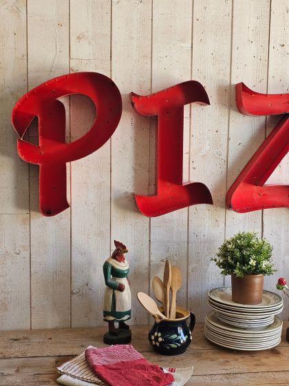 Anciennes lettres d'enseigne industrielles en métal formant le mot PIZZA